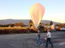 Lee and Ron walk the balloon out for launch. [Photo by Bob Snelgrove, KG6TBY]

